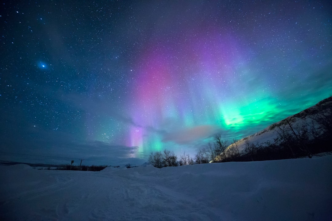 northern lights over snow-capped mountian