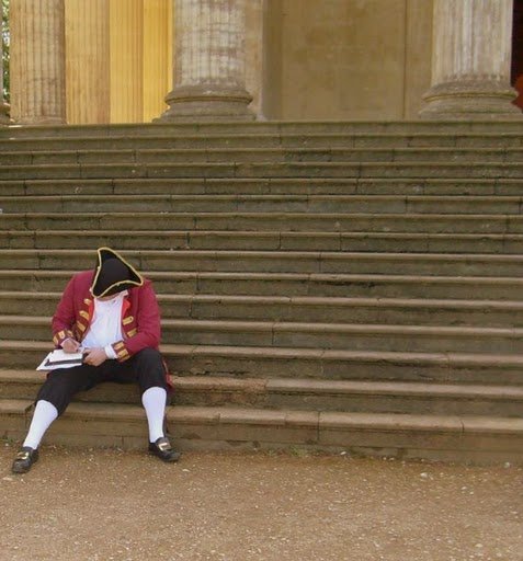 Ian writing on the steps of Wrest Park